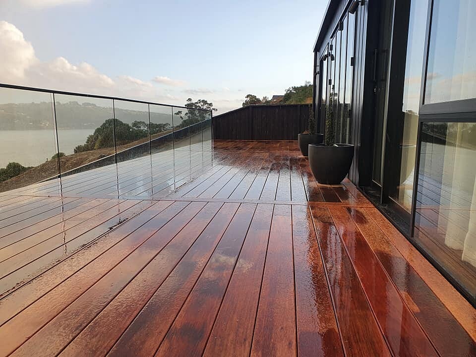 Hardwood deck with glass balustrade overlooking the water