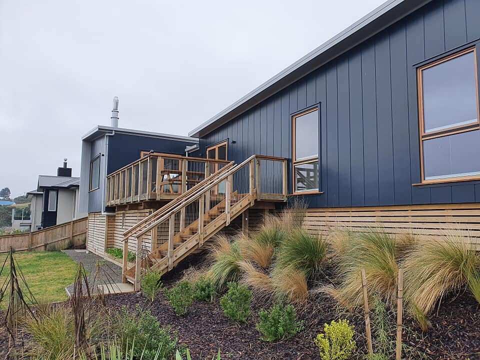 New build with timber stairs, deck and fresh landscaping